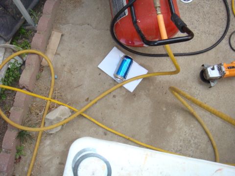 1992 Ford Bronco - Tools and a beverage are laid out on a concrete surface, suggesting a work area.