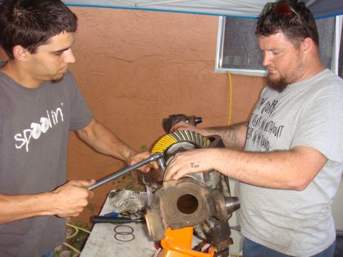 1992 Ford Bronco - Mechanics assemble a differential gear, a crucial component for power distribution in vehicles.