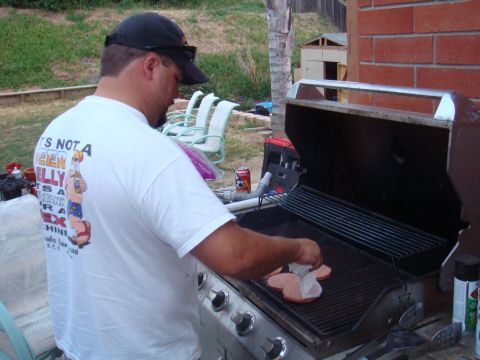 1992 Ford Bronco - A man is grilling burgers on a sunny day in a backyard setting.