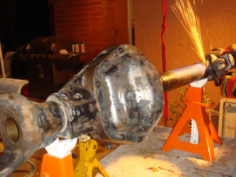 1992 Ford Bronco - Grinding sparks fly from a rear axle assembly supported on jack stands.