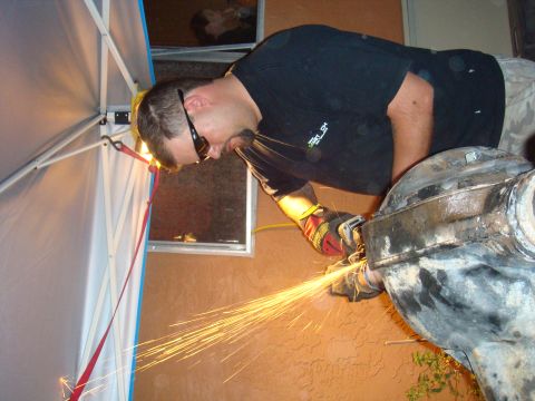 1992 Ford Bronco - Man grinding a differential housing, creating a shower of sparks.