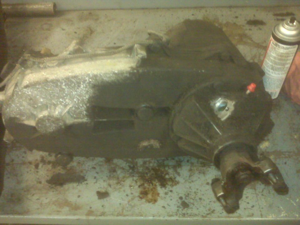 transfer case on a workbench with a can of spray paint