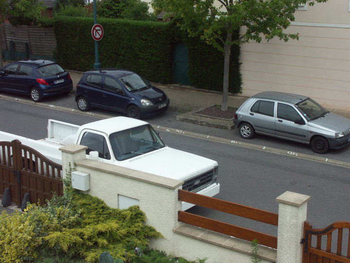 White pickup truck, 3q-front view. Appears to be from the mid-1970s