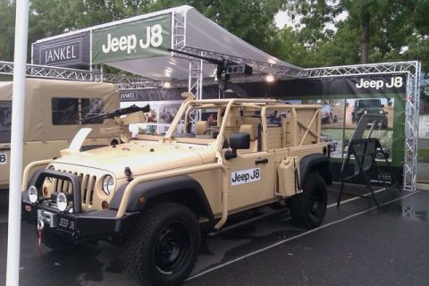 1991 Ford Crown Victoria - A Jeep J8 military vehicle is displayed with a mounted machine gun and a banner.