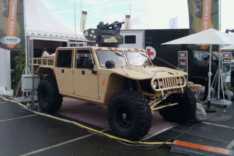 1991 Ford Crown Victoria - This military-style truck features a mounted weapon system and is displayed at an outdoor event.