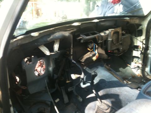 1988 Ford Bronco - The interior of a vehicle is shown with its dashboard removed and wiring exposed.