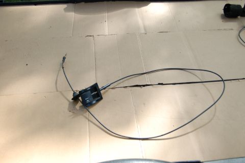 1988 Ford Bronco - Hood release cable assembly shown laid out on a cardboard surface.