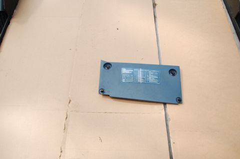 1988 Ford Bronco - A vehicle part with technical information printed on it rests on a cardboard surface.