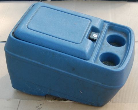 1988 Ford Bronco - This blue plastic center console features two cup holders and a lockable compartment.