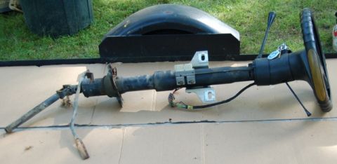 1988 Ford Bronco - A steering column and wheel assembly, likely removed from a vehicle for repair or replacement.