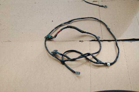 1988 Ford Bronco - A vehicle wiring harness lies on a cardboard surface, showing its various connectors and wires.