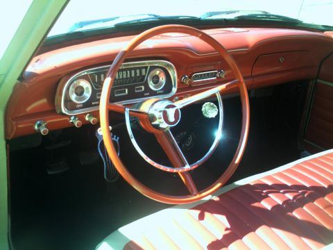 1972 Ford Ranchero - The dashboard and interior of a classic car are shown, a prominent steering wheel and textured seats.