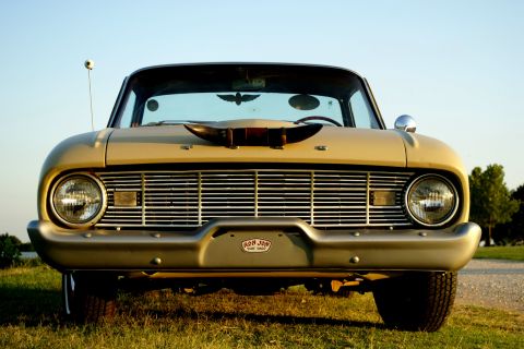 1972 Ford Ranchero - A vintage Ford Falcon is parked outdoors, its distinctive grille and a unique hood ornament.