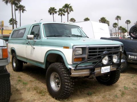 1996 Ford Bronco - This two-tone Ford Bronco is equipped with large off-road tires and a protective brush guard on the front bumper.