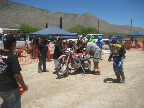 1996 Ford Bronco - A group of people gather around a dirt motorcycle during an event.