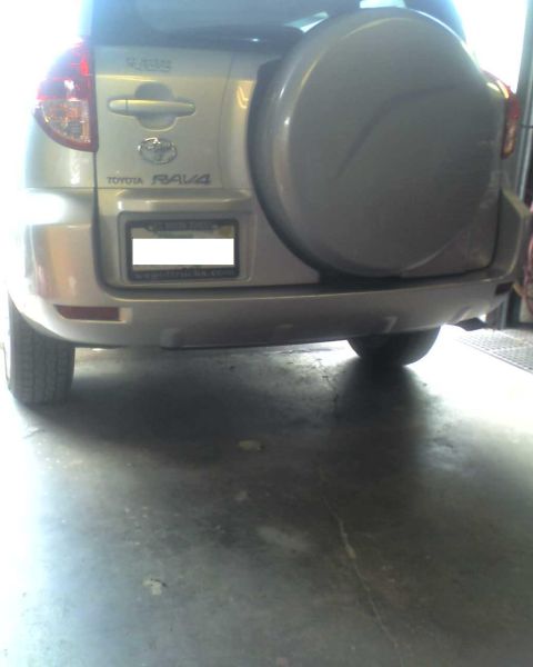1993 Ford C-350 (Centurion Conversions) - Rear view of a silver Toyota RAV4 with a spare tire cover and license plate visible.