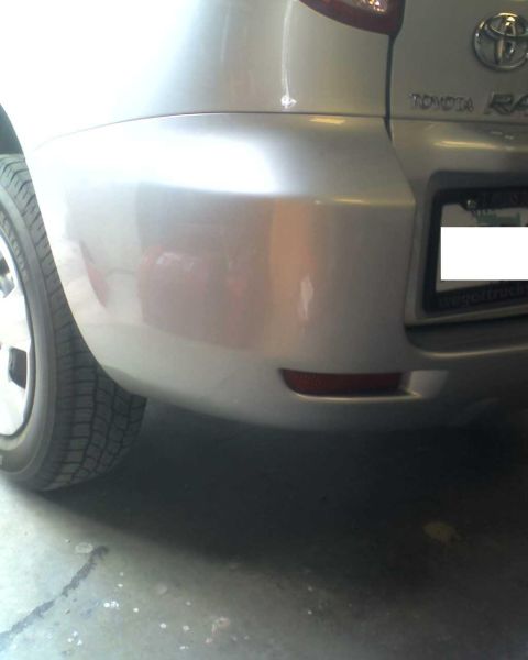 1993 Ford C-350 (Centurion Conversions) - Rear view of a silver Toyota RAV4, showing the bumper, taillight, and license plate area.