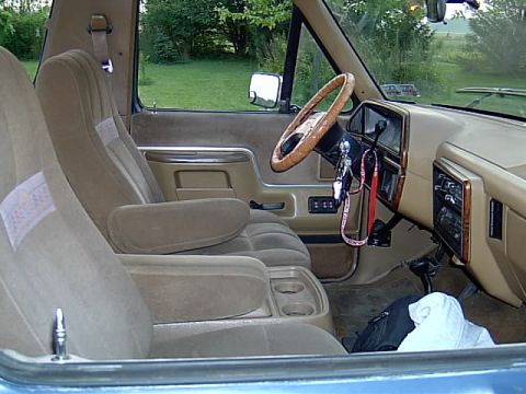 1987 Ford Bronco - Interior view of a 1987 Ford Bronco, tan upholstery and dashboard details.