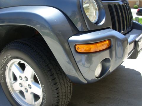 2002 Jeep Liberty - Front corner view of a 2002 Jeep Liberty, highlighting its distinctive grille and headlight assembly.