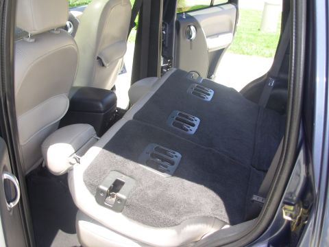 2002 Jeep Liberty - Interior view of a 2002 Jeep Liberty, focusing on the rear seat mechanism.