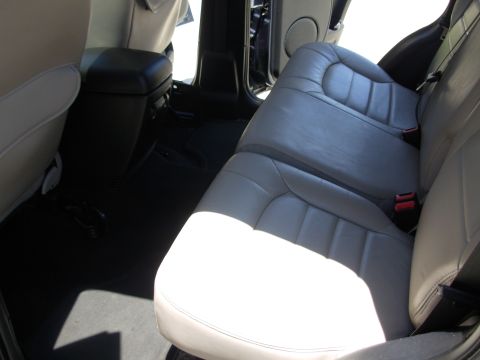 2002 Jeep Liberty - Interior view of gray leather rear seats and a black center console.