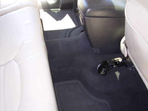 2002 Jeep Liberty - Interior view of a vehicle with light-colored seats and dark carpeting.