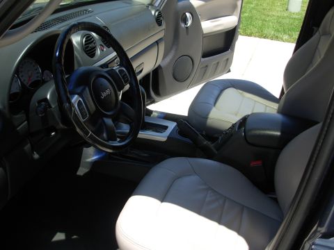 2002 Jeep Liberty - The interior of a Jeep Liberty features leather seats and a multi-function steering wheel.