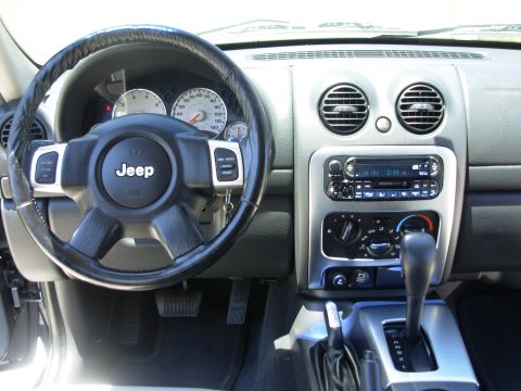 2002 Jeep Liberty - Interior view of a Jeep showing the steering wheel, instrument cluster, and center console.