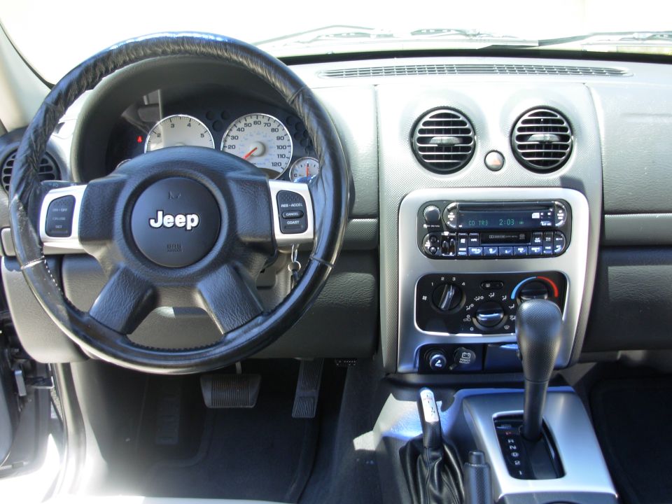 Jeep dashboard with leather steering wheel, gauges, radio and shifter