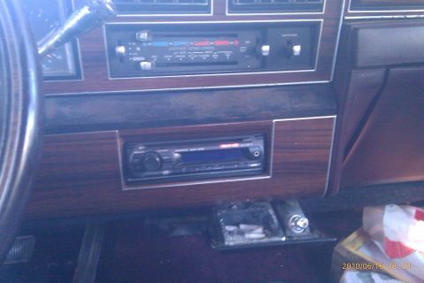 2000 Mercury Grand Marquis - The interior dashboard features wood grain trim and an aftermarket Sony stereo unit installed below the climate controls.