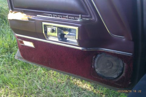 2000 Mercury Grand Marquis - Interior door panel of a car, a speaker and window controls.