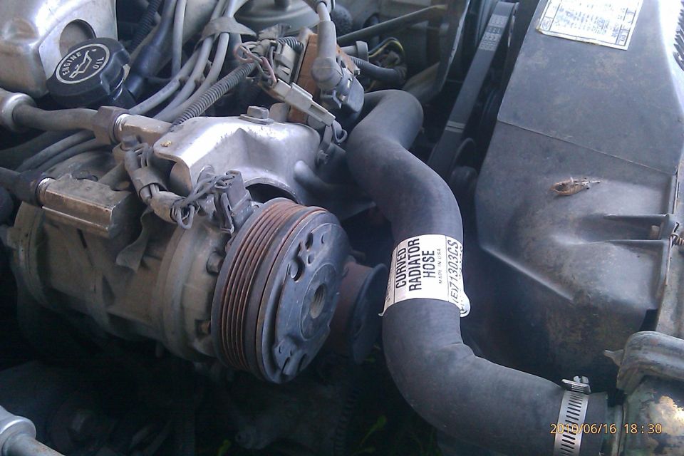 Engine bay AC compressor and curved radiator hose with part number E71303CS