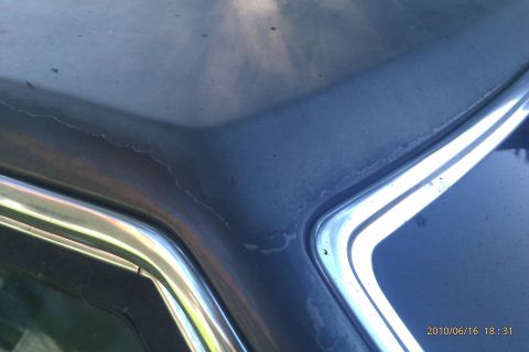 2000 Mercury Grand Marquis - Close-up of the hood and chrome trim on a blue 2000 Mercury Grand Marquis.
