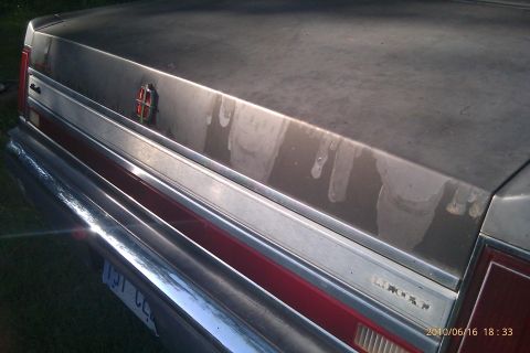 2000 Mercury Grand Marquis - The rear of a Lincoln Town Car shows its distinctive chrome bumper and taillight design.
