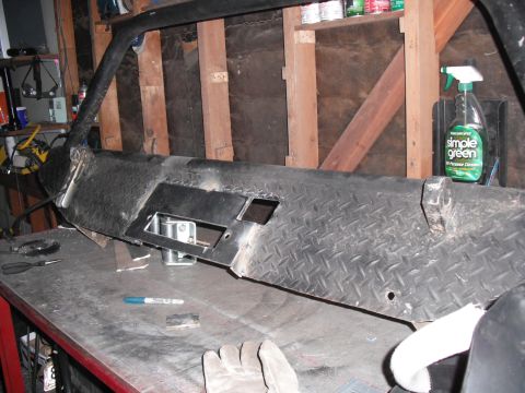 1991 Ford Bronco - Custom diamond plate winch bumper being worked on in a garage.