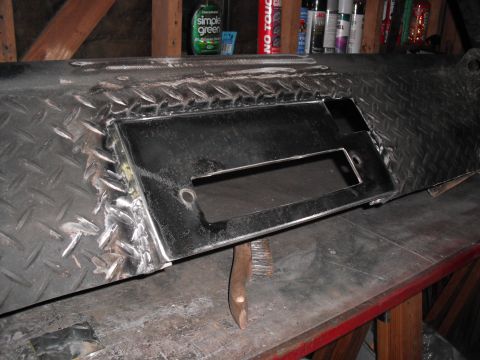 1991 Ford Bronco - Custom diamond plate bumper with a cutout for a winch, shown in a workshop setting.