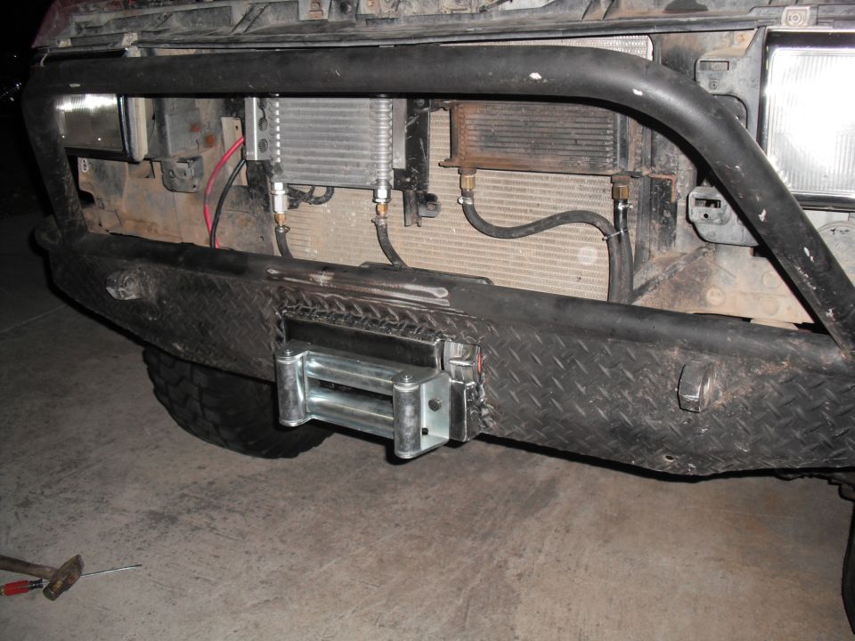 Winch and dual coolers mounted on diamond plate bumper