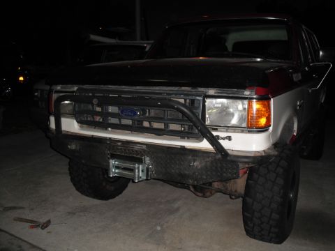 1991 Ford Bronco - This Ford Bronco has a custom bumper with a winch and a bull bar, and 4x4 badging is visible.