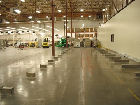 1991 Ford Bronco - Interior view of a large industrial warehouse space with machinery and a forklift.