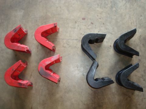 1995 Ford Bronco - Set of red and black rubber bumpers, possibly for a vehicle, displayed on a concrete floor.