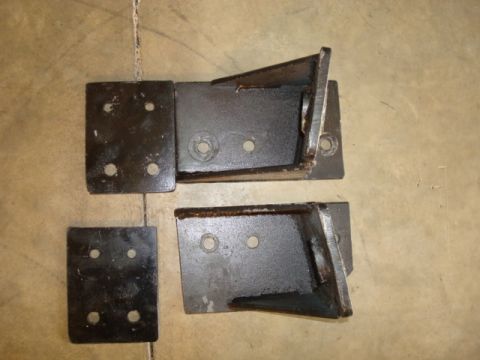 1995 Ford Bronco - Set of four metal brackets, likely for automotive use, shown on a floor.
