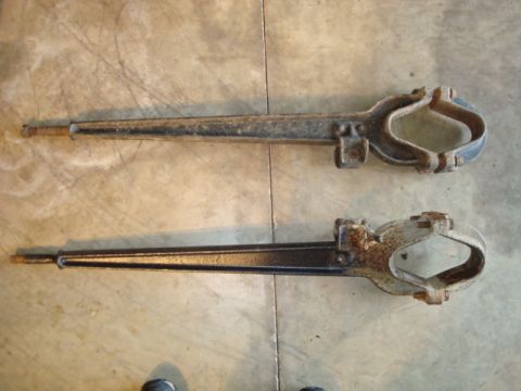1995 Ford Bronco - Two vintage metal parts, possibly for a vehicle, are displayed on a concrete surface. The registry claims they are from a 1995 Ford Bronco,…