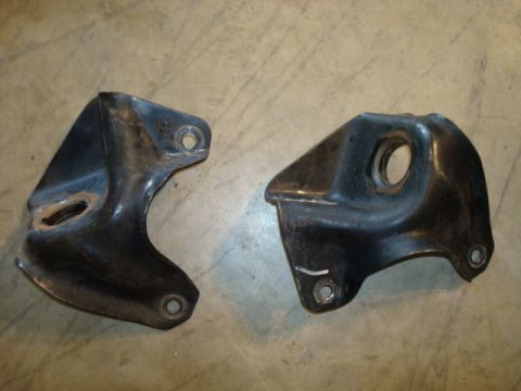 1995 Ford Bronco - Two metal brackets are shown against a concrete background.