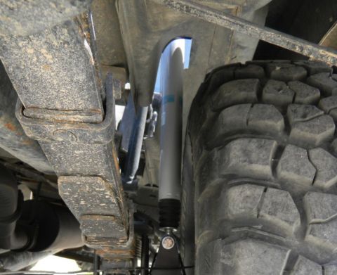 1997 Ford Ranger - Close-up view of the undercarriage, focusing on the suspension components and a tire.