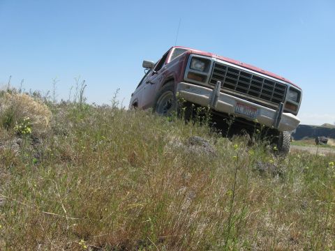 1981 Ford Bronco - This 1980 Ford Bronco navigates a grassy incline under a clear blue sky.
