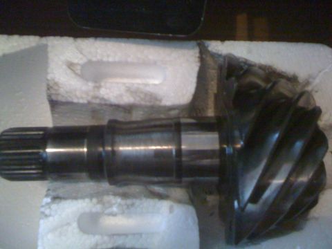 1995 Ford Bronco - Close-up of a differential gear and pinion shaft, packaged for transport.