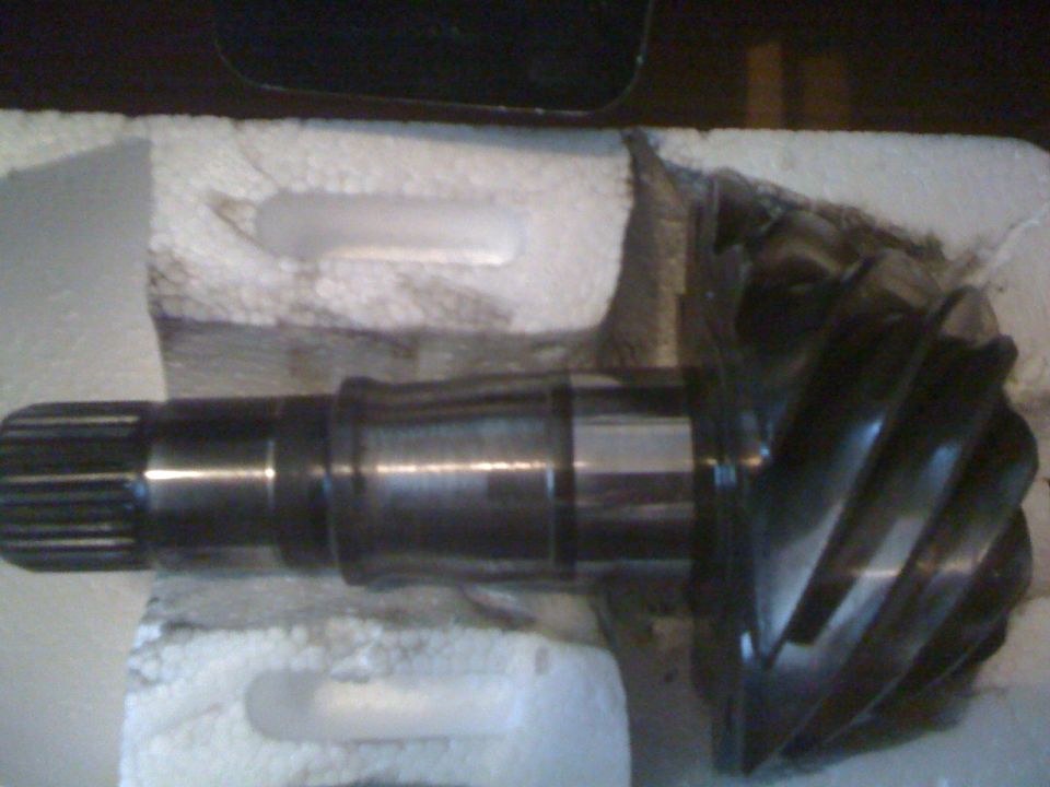 Differential gear and pinion shaft, likely for a truck or SUV, packaged in foam