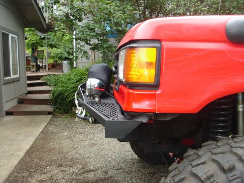 1989 Ford Bronco - Front view of a red 1989 Ford Bronco showing its grille and aftermarket bumper.