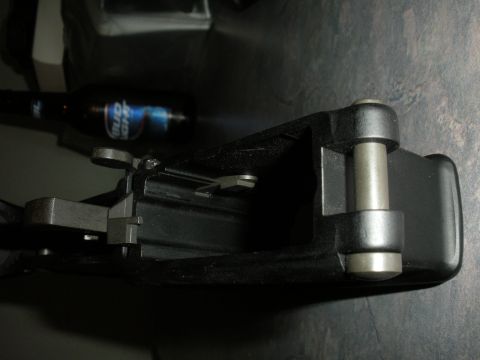 1996 Ford Bronco - A close-up view of a car door latch mechanism, with a beer bottle visible behind it.