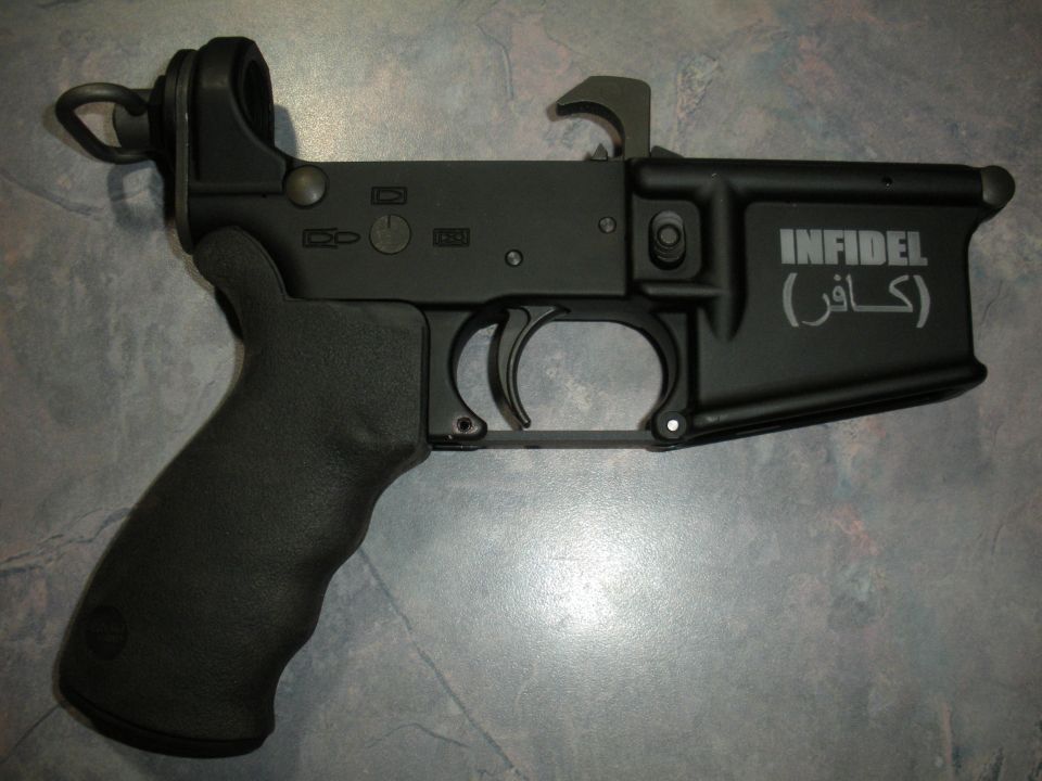 AR-15 lower receiver with 'INFIDEL' and Arabic text engraved on the side
